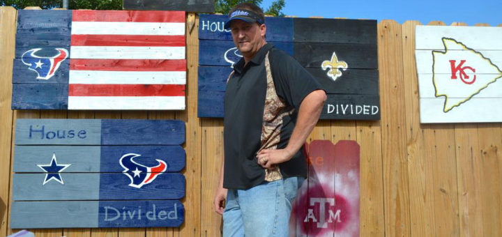 Sign guy stands near his work