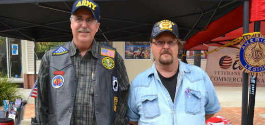 Two Vietnam veterans at a booth