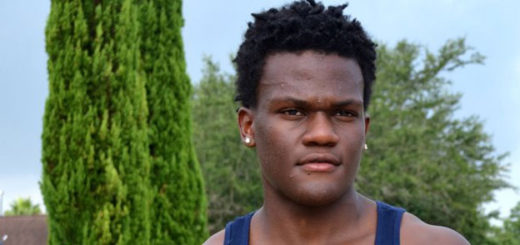 Young man stands in yard