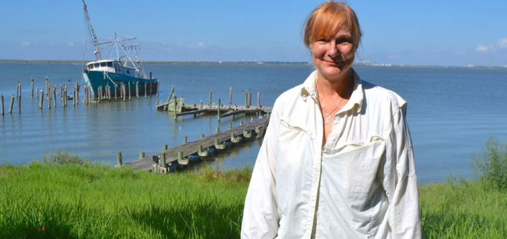 Widow stands in her yard