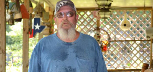 Woodworker stands on back porch