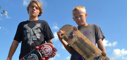 Two boys holding skateboards