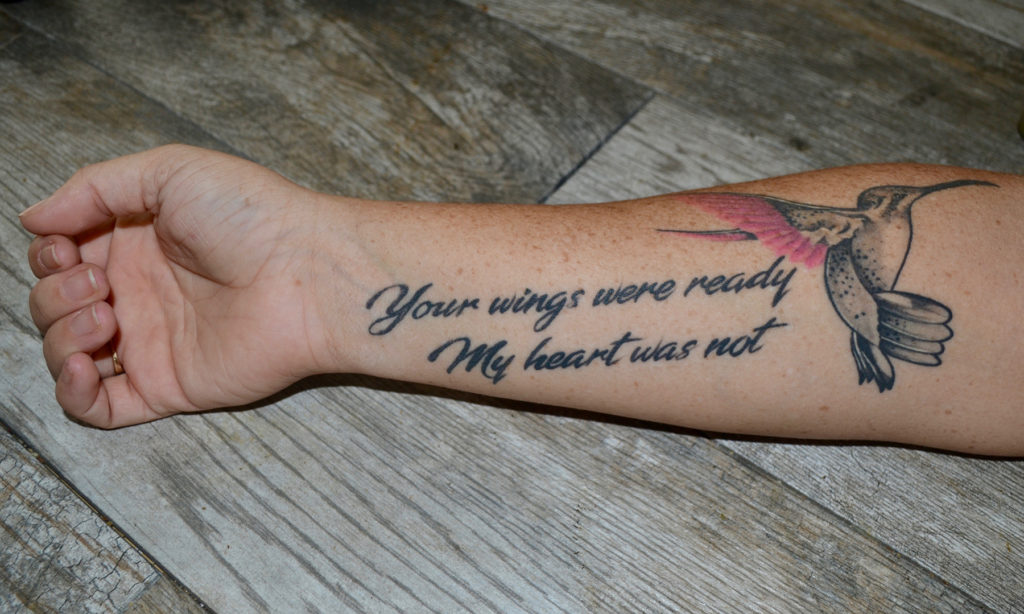 Arm tattoo of a hummingbird