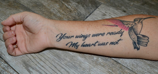 Arm tattoo of a hummingbird