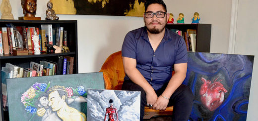 Joshua Villegas with some of his paintings