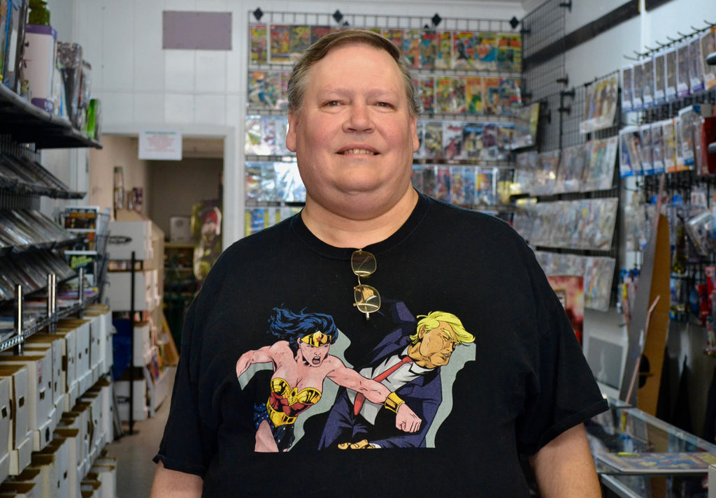 Norris Coleman stands inside his comic shop