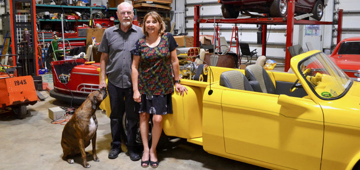 Cindy and Ron Fehring with their dog in their barndominium's large shop