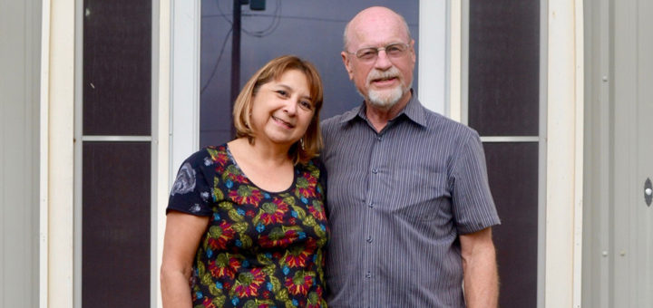 Cindy and Ron Fehring with their dog in front of their home