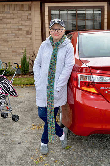 Betty Arabie stands near her car