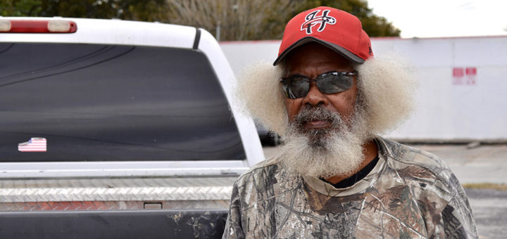 Glen Henson stands next to a truck