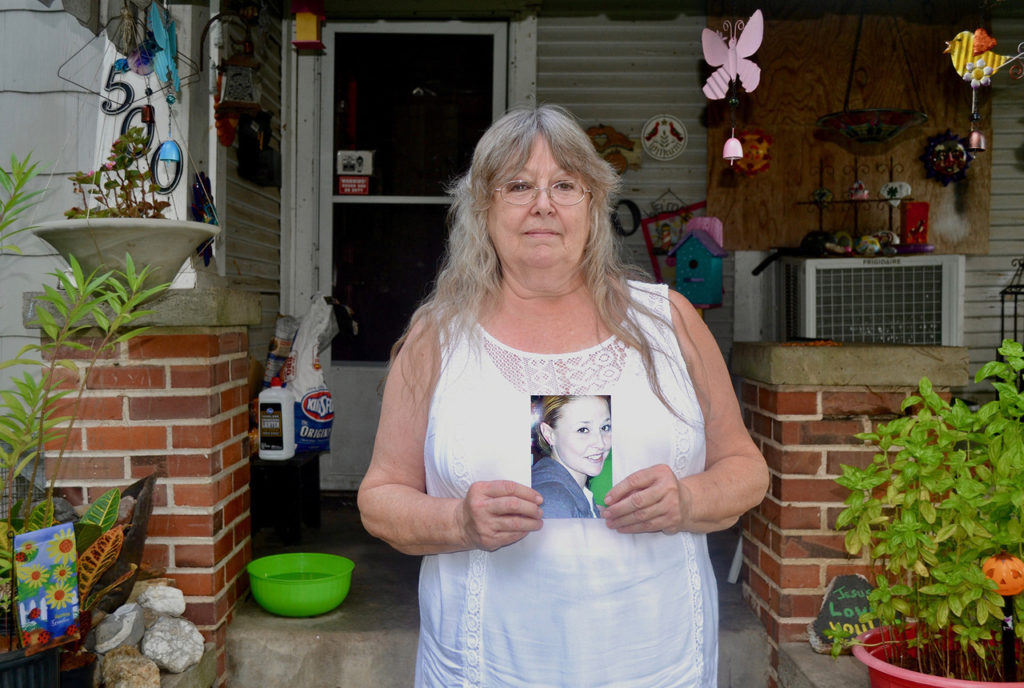 Marian Mims holds photo of her daughter