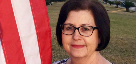 Nova Stippel stands next to an American flag