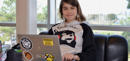 Madilyn Lawrence sits with her laptop computer