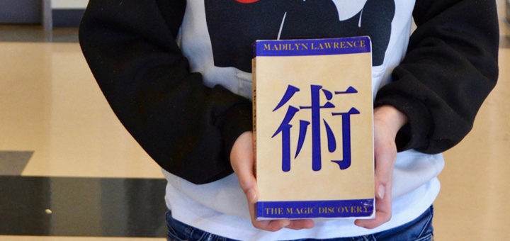 Madilyn Lawrence holds a book that she wrote