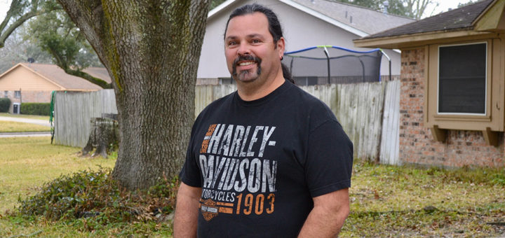Richard Vargas stands in his front yard