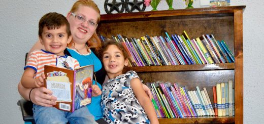 Betty Rosario and her children at the free little library