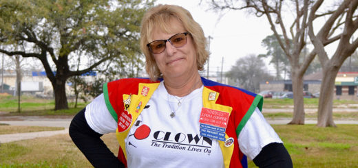 Linda Cooper stands in front of the library