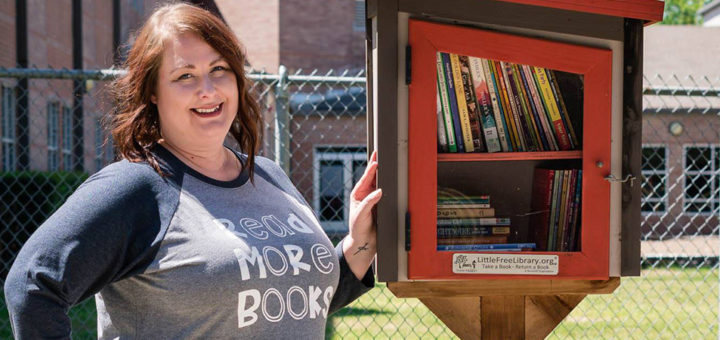 Amanda Rayburn next to the Little Free Library
